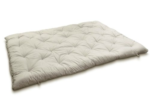 Outstretched wool-filled and tufted mattress topper.