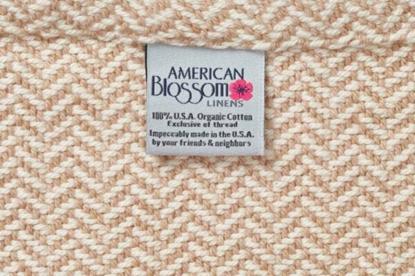 close up of American Blossom herringbone twill weave organic cotton blanket in Patriot Blue.