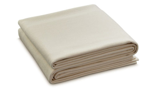 An undyed merino wool blanket, folded neatly against a white background.