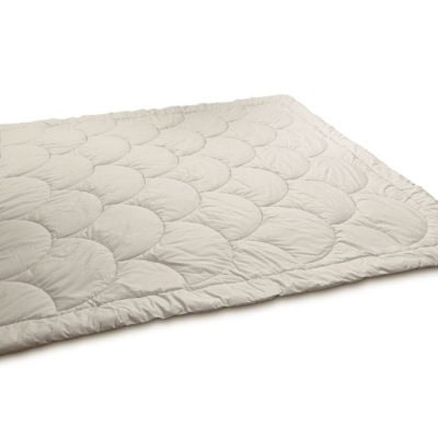 Outstretched wool comforter with a shell pattern stitching. Against white background.