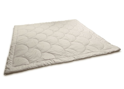 Outstretched wool comforter with a shell pattern stitching. Against white background.