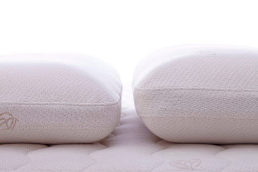 Two latex pillows side by side showing the difference in heights.