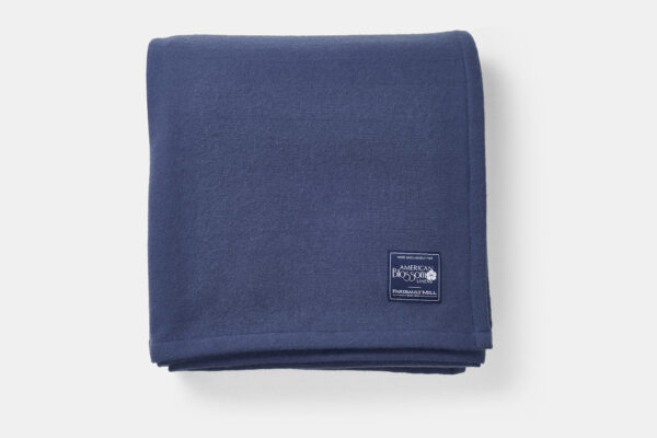 Folded blue virgin lightweight wool blanket