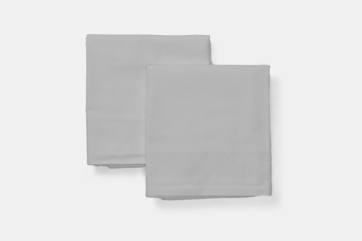 Two folded stacked cotton percale pillowcases in steel grey
