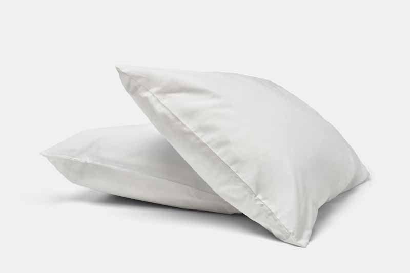 Two natural cotton percale pillowcases stacked in white