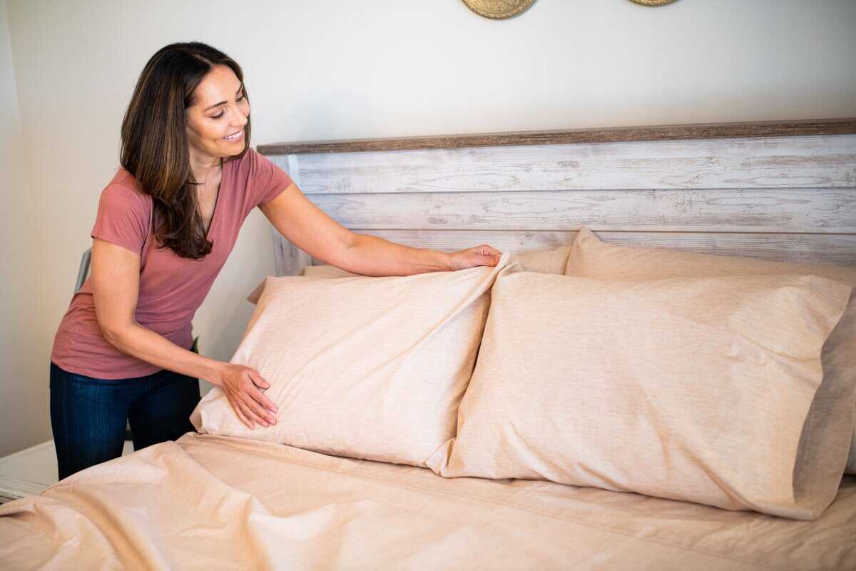 Woman adjusting Natural Colored FoxFibre Cotton Percale Pillows