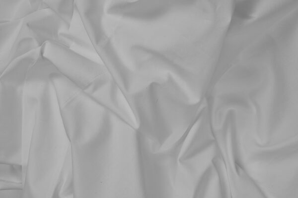 close up of natural cotton percale sheets in steel grey
